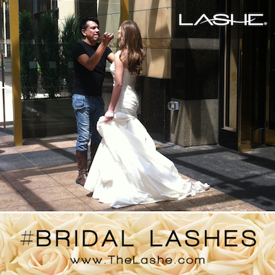 Bride with full eyelash extensions receiving makeup touch-ups before her wedding